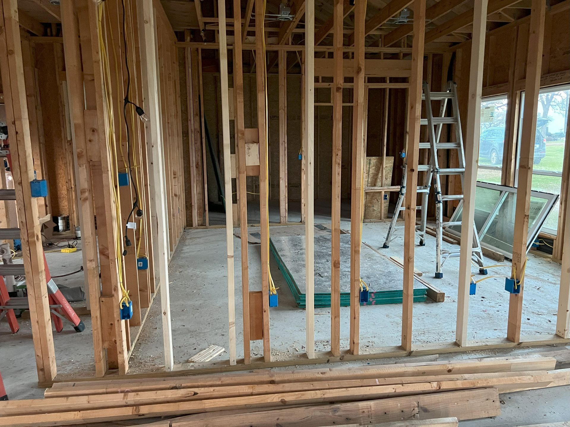 A house is being built with wooden beams and a ladder.