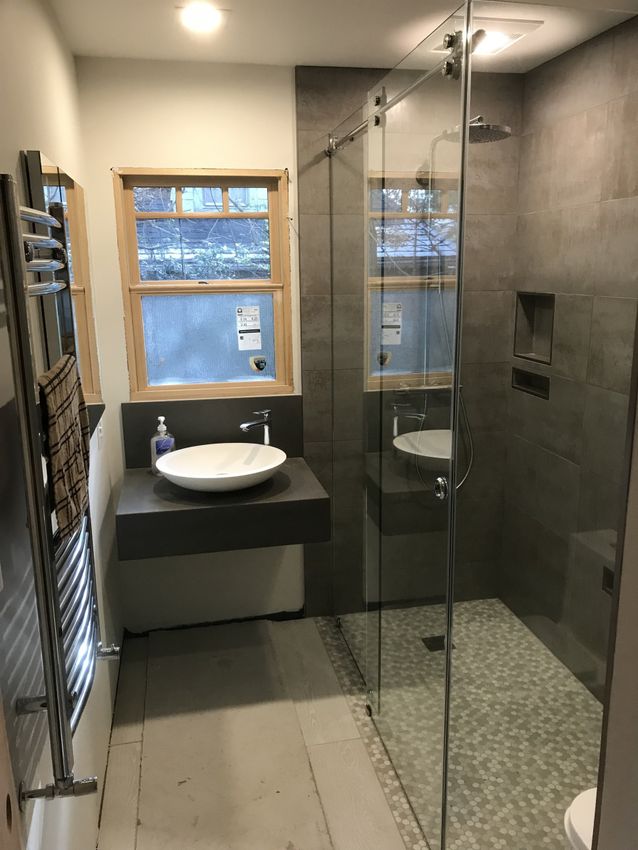 Frameless glass shower with sleek hardware by Rhodes Glass Asheville, NC.