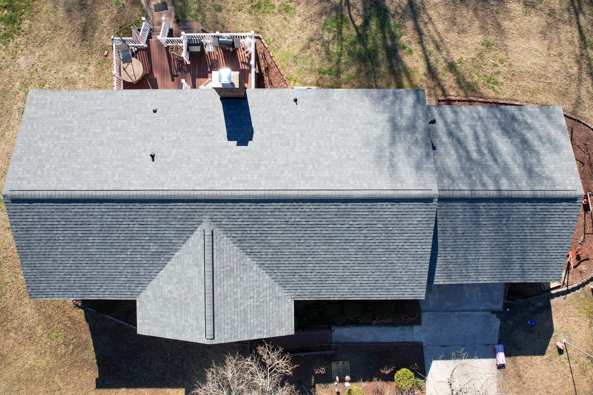 An aerial view of a house with a gray roof