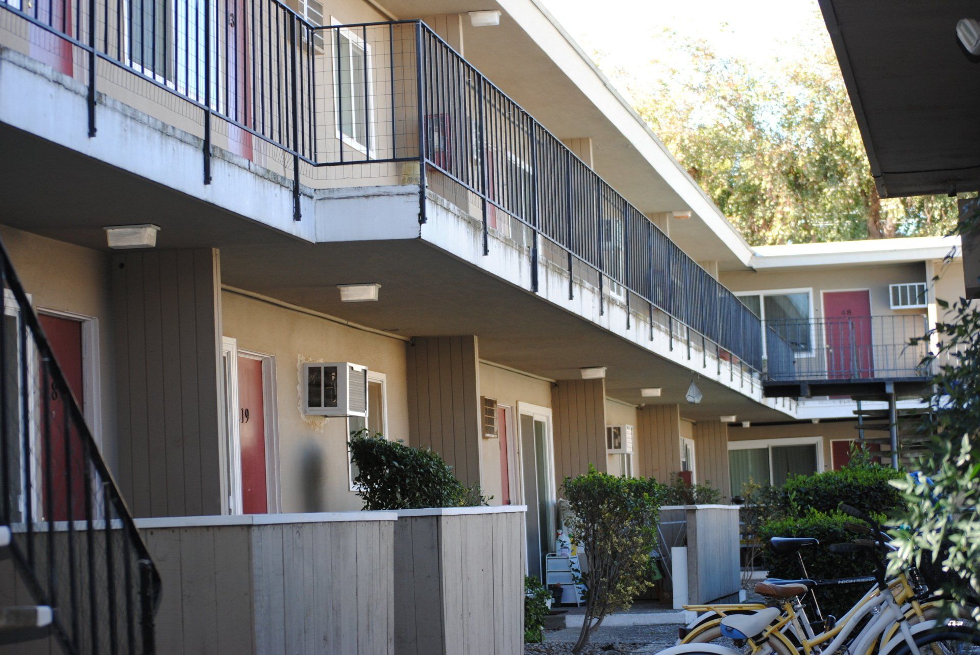 Exterior of University House apartment complex with pool