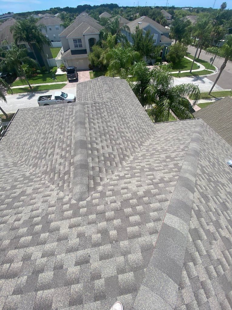 An aerial view of a roof of a house in a residential area.