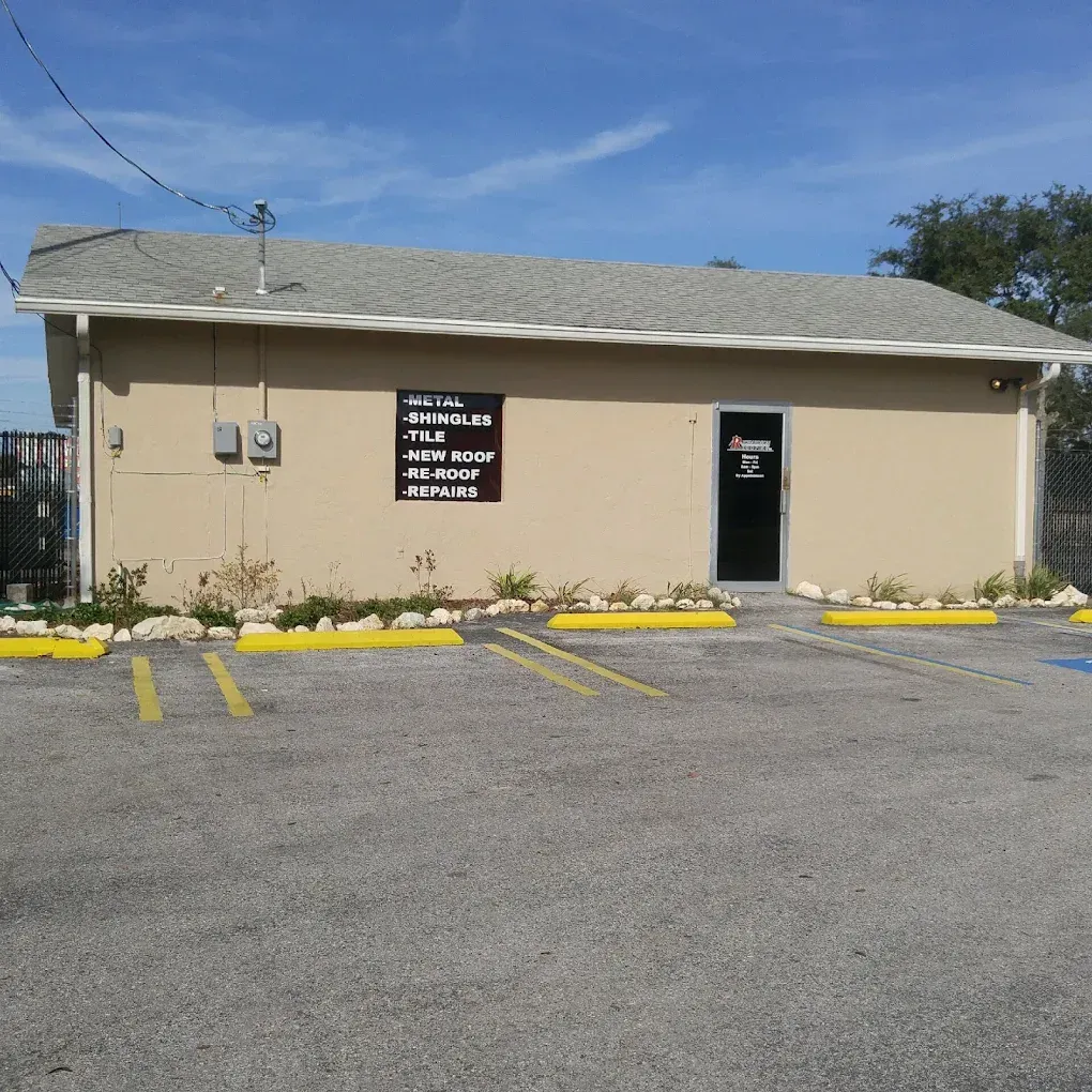 A large house is being built in the middle of a dirt field.