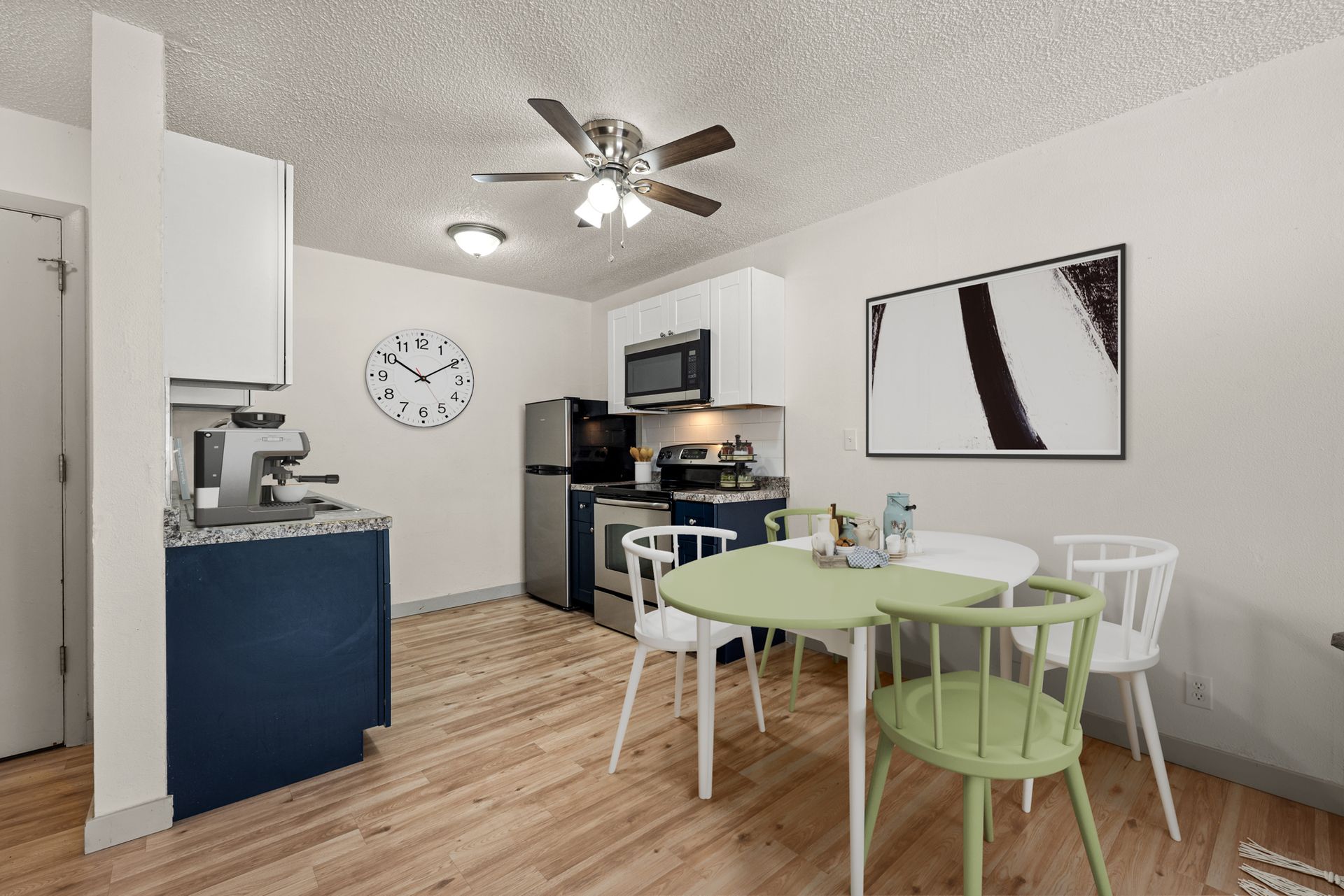 Photo showing a small kitchen with a nearby dining area