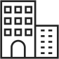 A black and white icon of a building with squares on it.