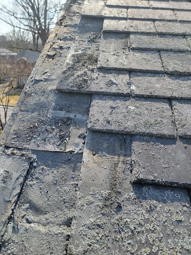 A close up of a roof with a lot of shingles on it.