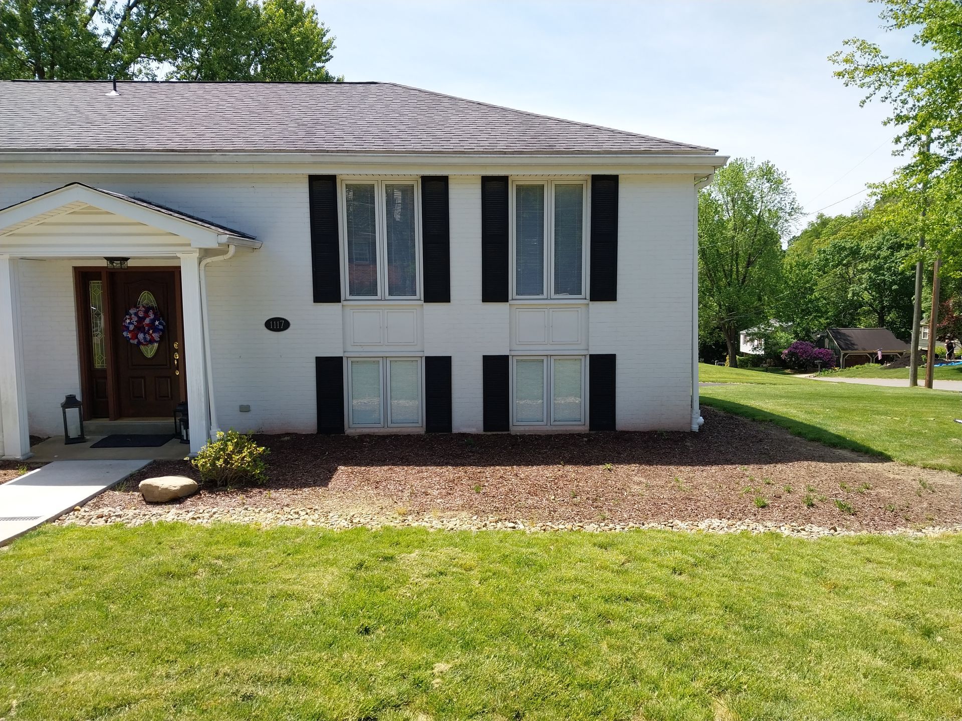 A white house with black shutters on the windows