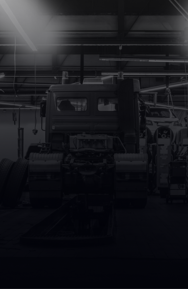 A semi-truck cab in a garage, with a light source on top. | Umphress Fleet Service LLC