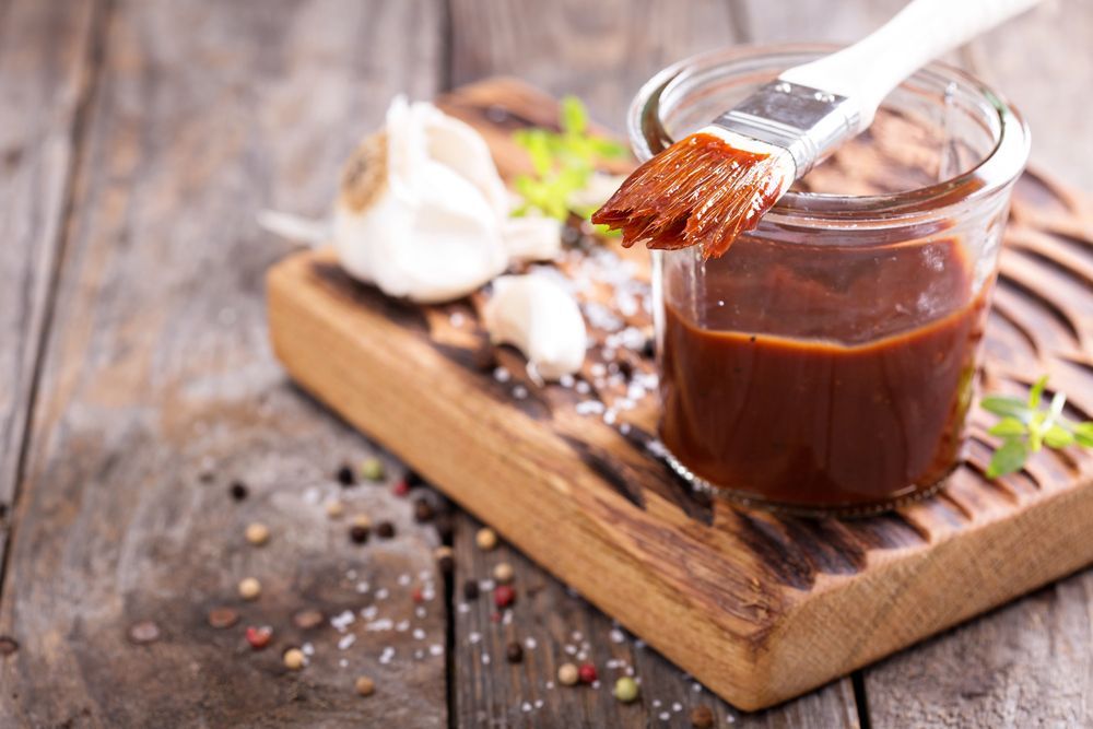 Jar of Barbecue Sauce With Brush on Wooden Board, Garlic, and Spices — CQ Butchers & Catering Supplies in Mackay, QLD