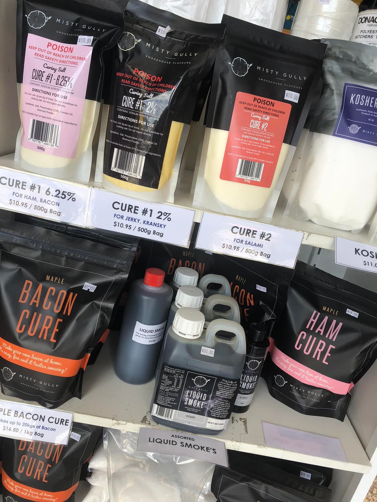 Shelves With Black Bags of Curing Mixes and Bottles of Liquids — CQ Butchers & Catering Supplies in Airlie Beach, QLD