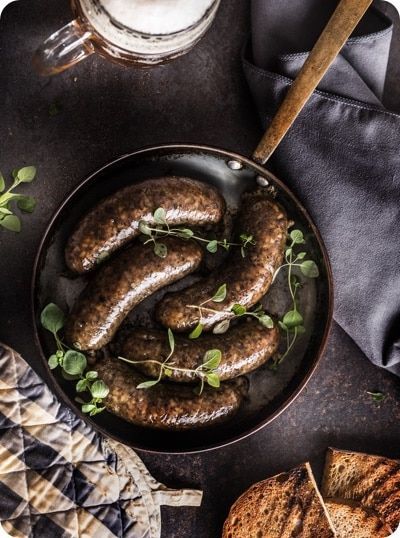 Sausages in a Pan With Herbs, a Mug of Beer, Bread, and Oven Mitt — CQ Butchers & Catering Supplies in Mackay, QLD