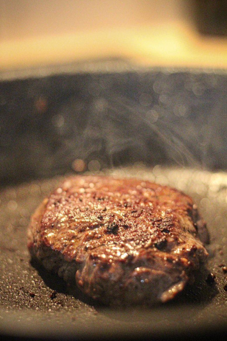 Steak Cooking in a Hot Pan; Brown Exterior, Steam Rising — CQ Butchers & Catering Supplies in Mackay, QLD