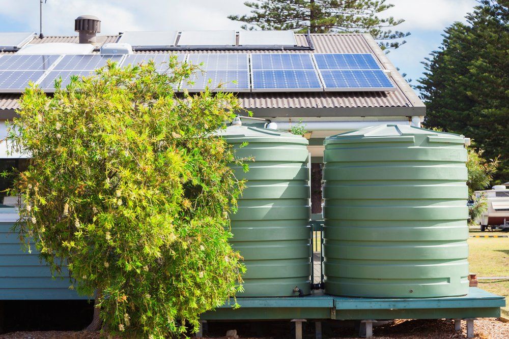 Water Tank And Solar Panels On House — Barney’s Tank Cleaning in Morisset, NSW