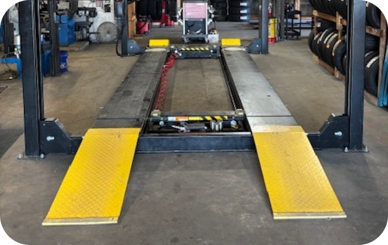 car on lift | Precision Tires Auto