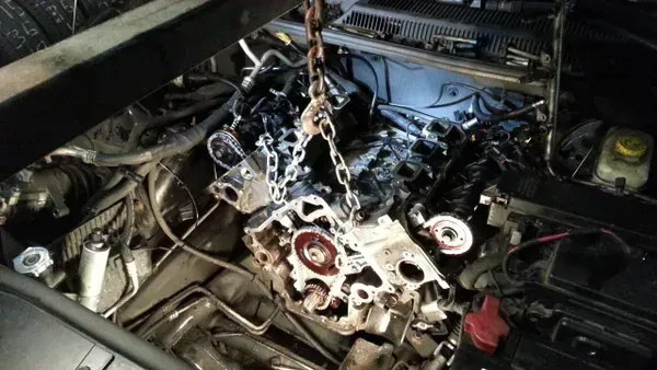 gallery engine lifted up with chains | Precision Tires Auto