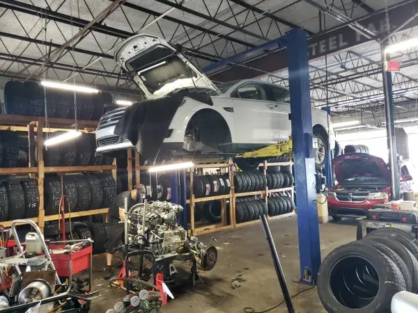 gallery hood up white car lifted | Precision Tires Auto