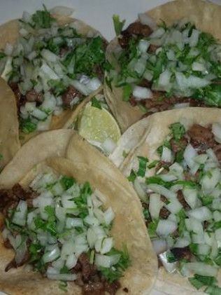 A bowl of chips and a bowl of salsa on a table in a restaurant.
