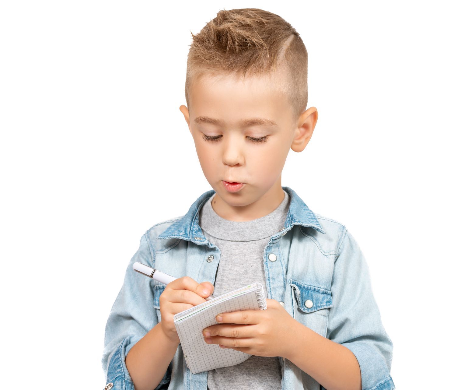 Young boy holding pen and paper.