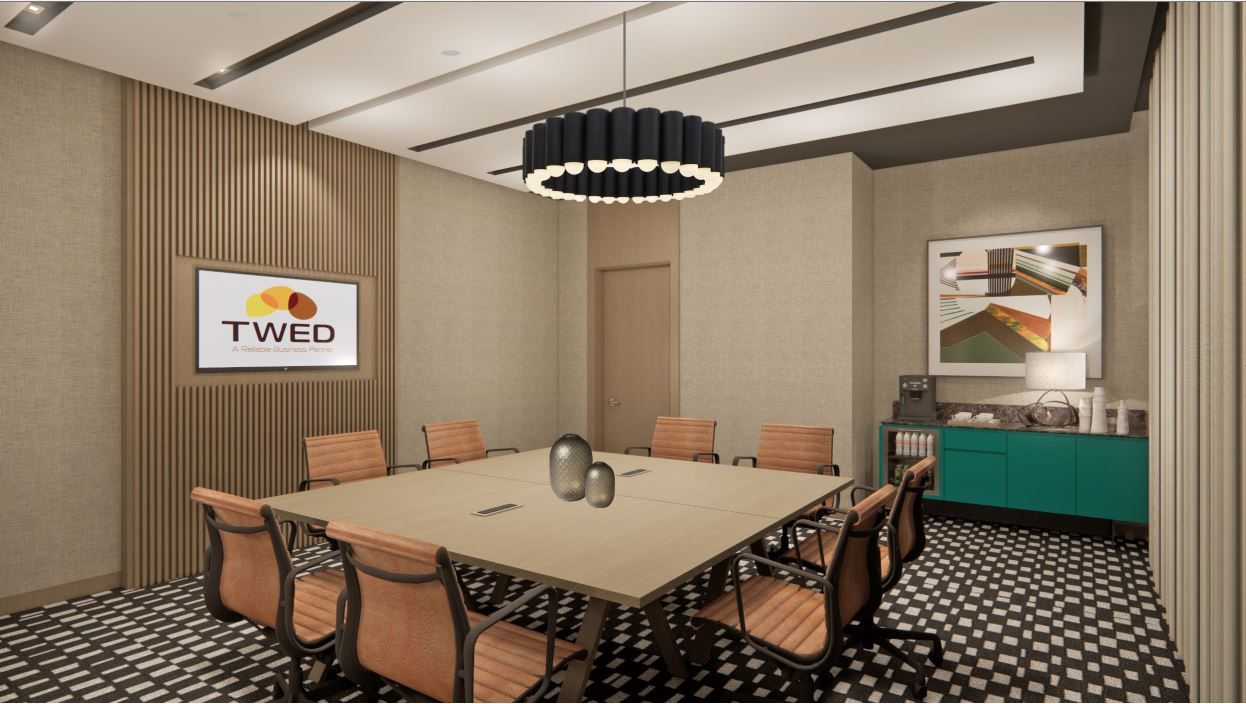 Conference room with a square table, orange chairs, and a TV with the 