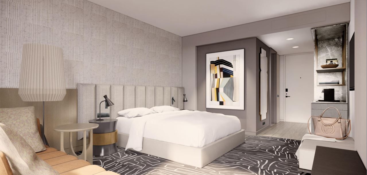 A modern bedroom with a bed, art, and built-in shelves; a neutral color palette.