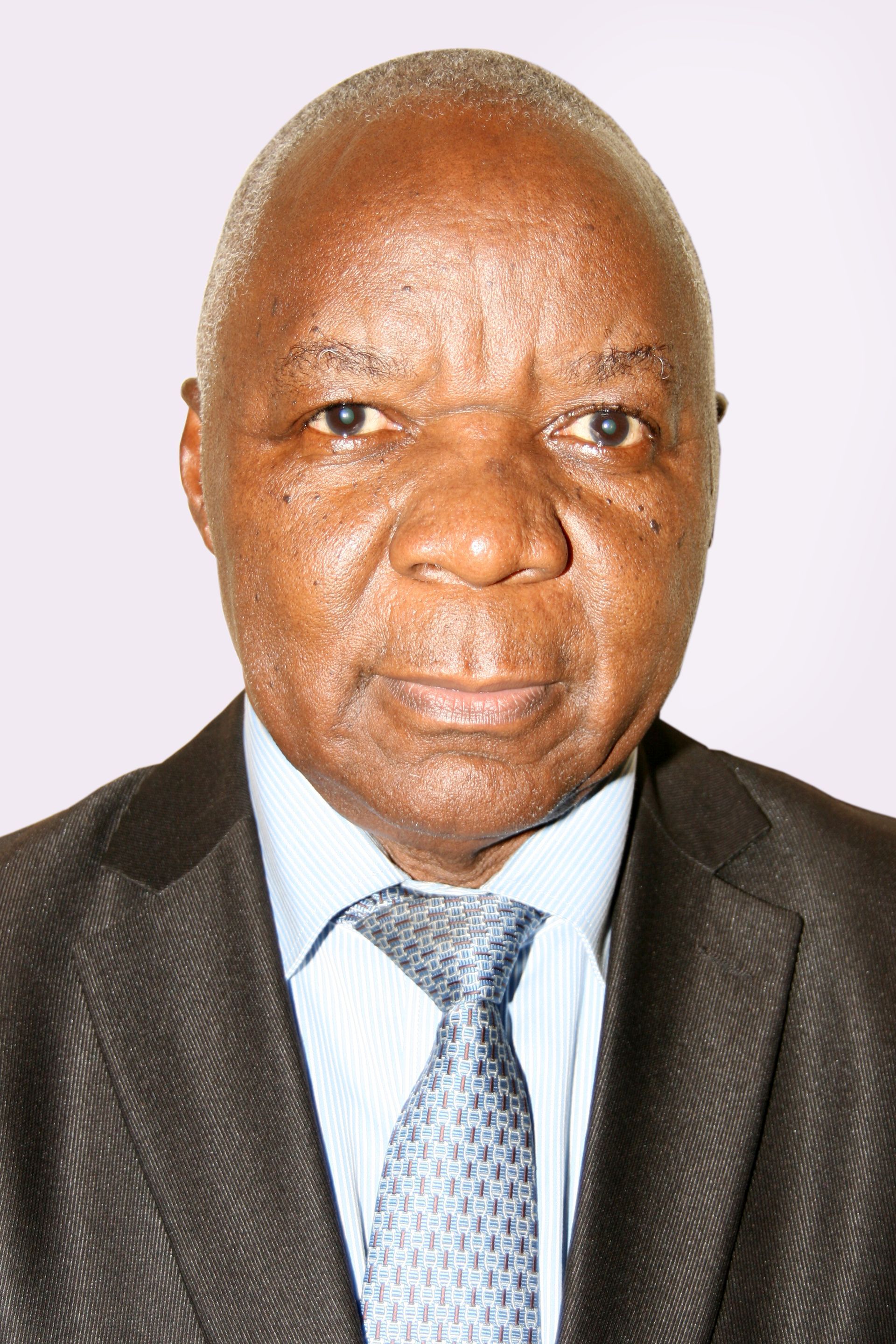 An older Black man wearing a suit and tie, looking directly at the camera.