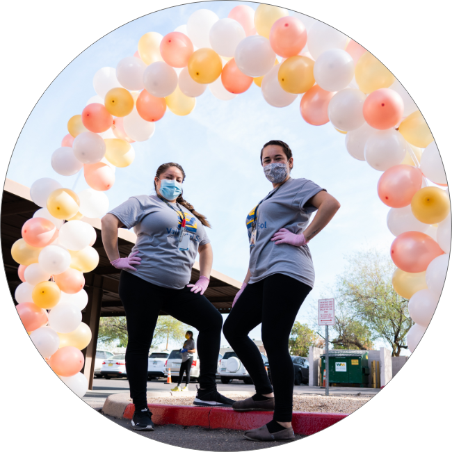 Valle del Sol employees under a balloon arch