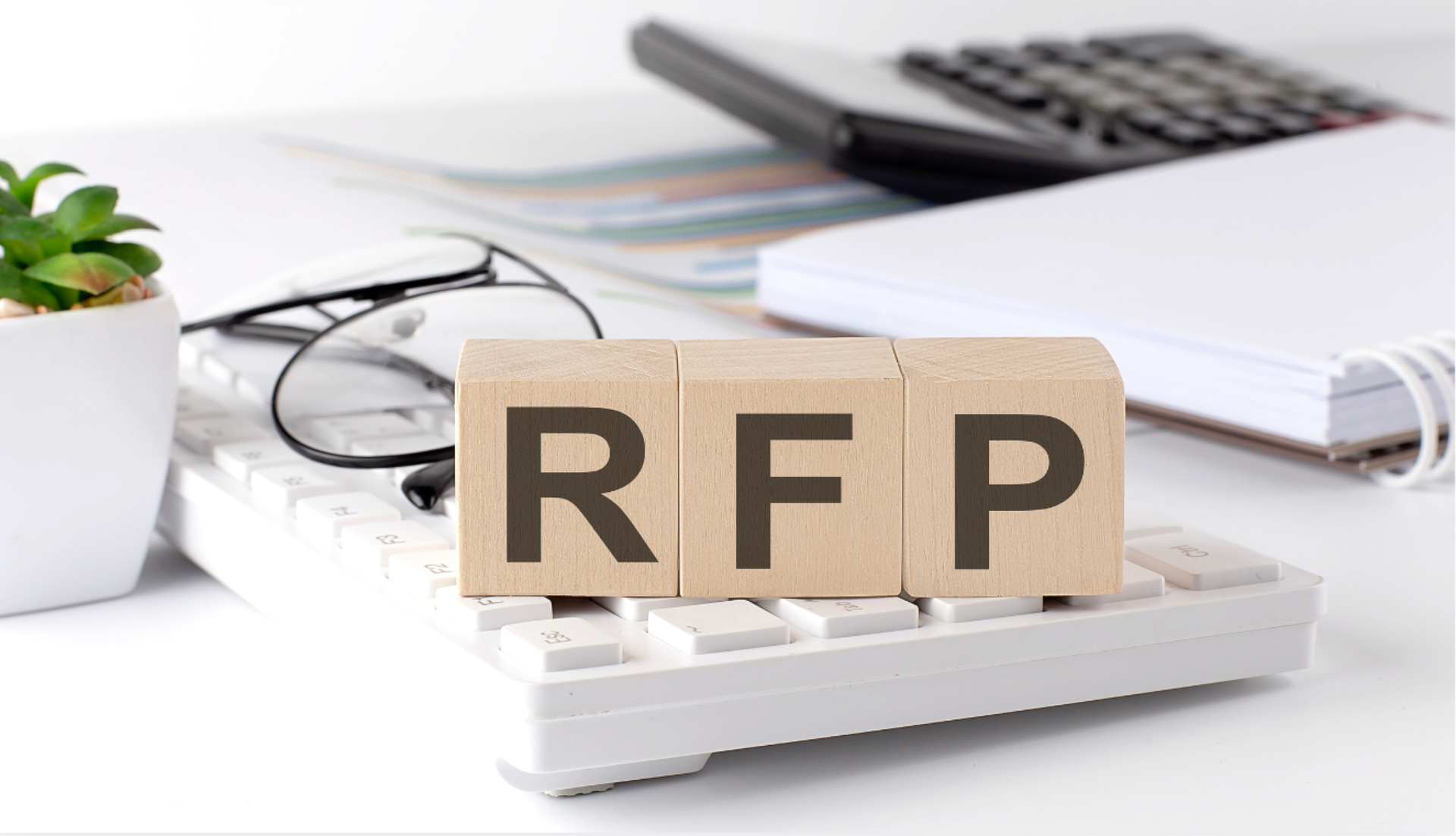 The word rfp is written on wooden blocks on top of a calculator. Accurate and effective request for proposal