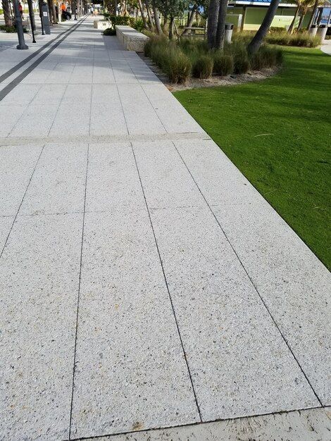 concrete driveway with green grass beside