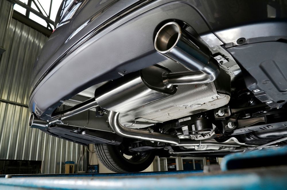Undercarriage Of a Car on a Lift, Showing the Exhaust System in a Garage Inspection Bay — Wingham Mechanical in Wingham, NSW