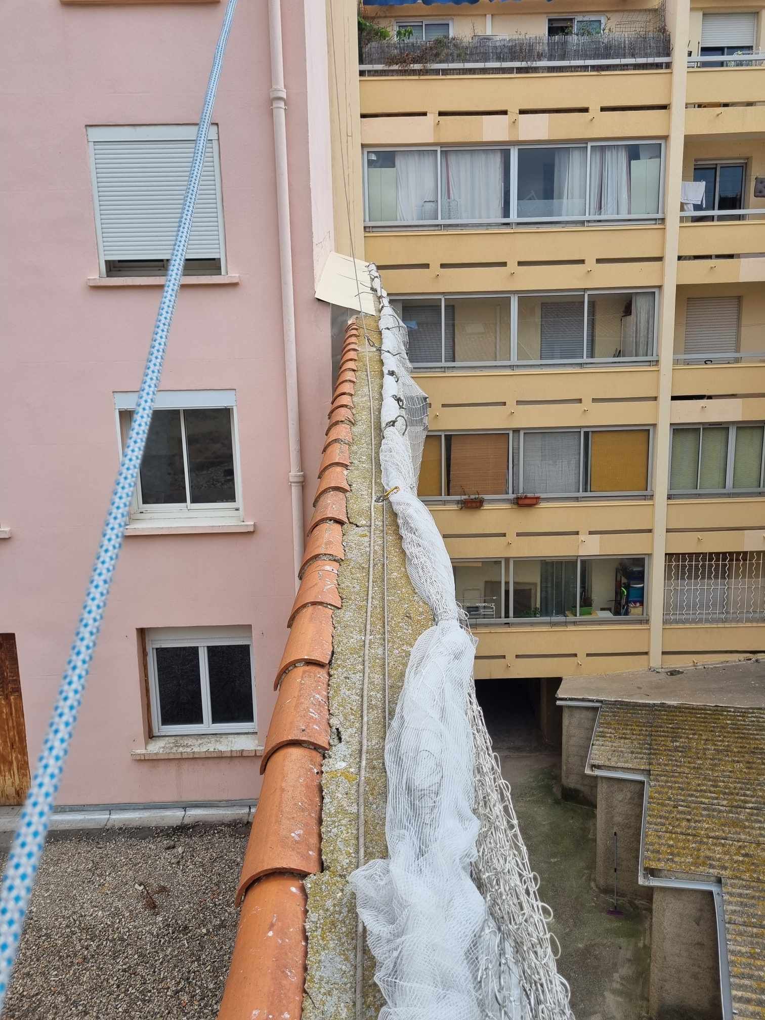 Un bâtiment avec beaucoup de fenêtres et une corde qui y pend