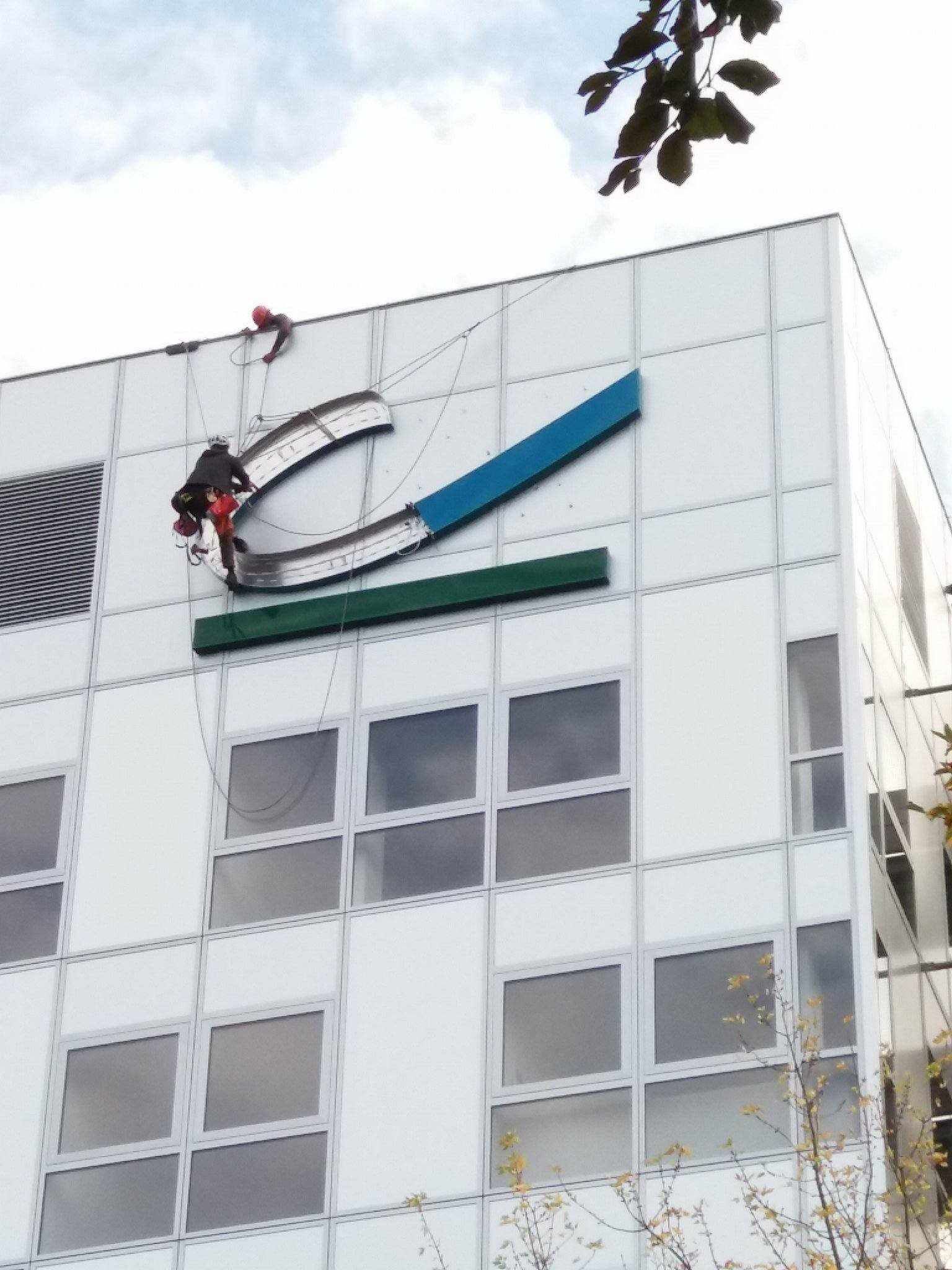 Un bâtiment blanc avec un logo bleu et vert dessus