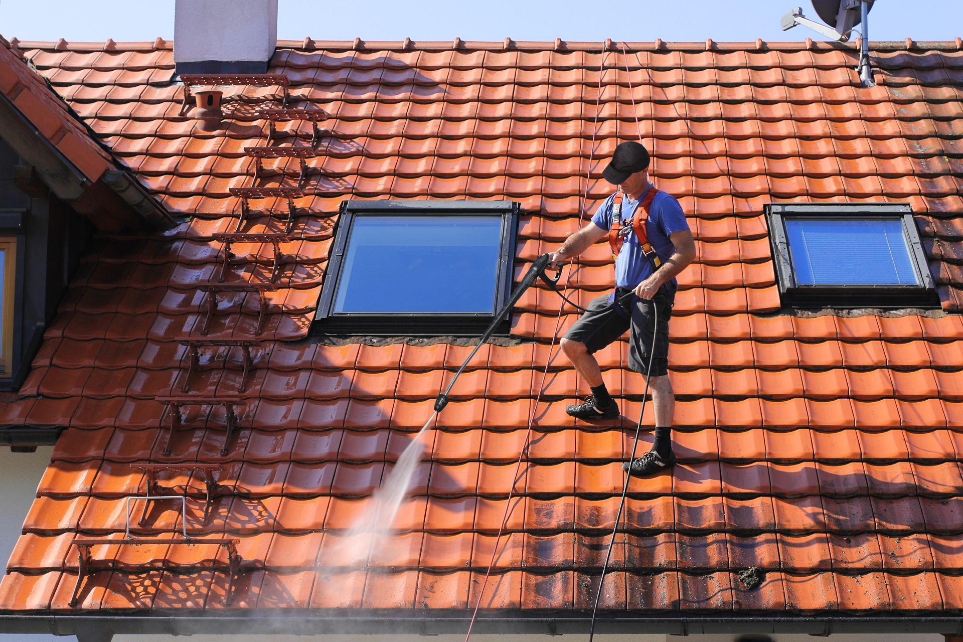 Professional Worker Cleaning Residential Roof