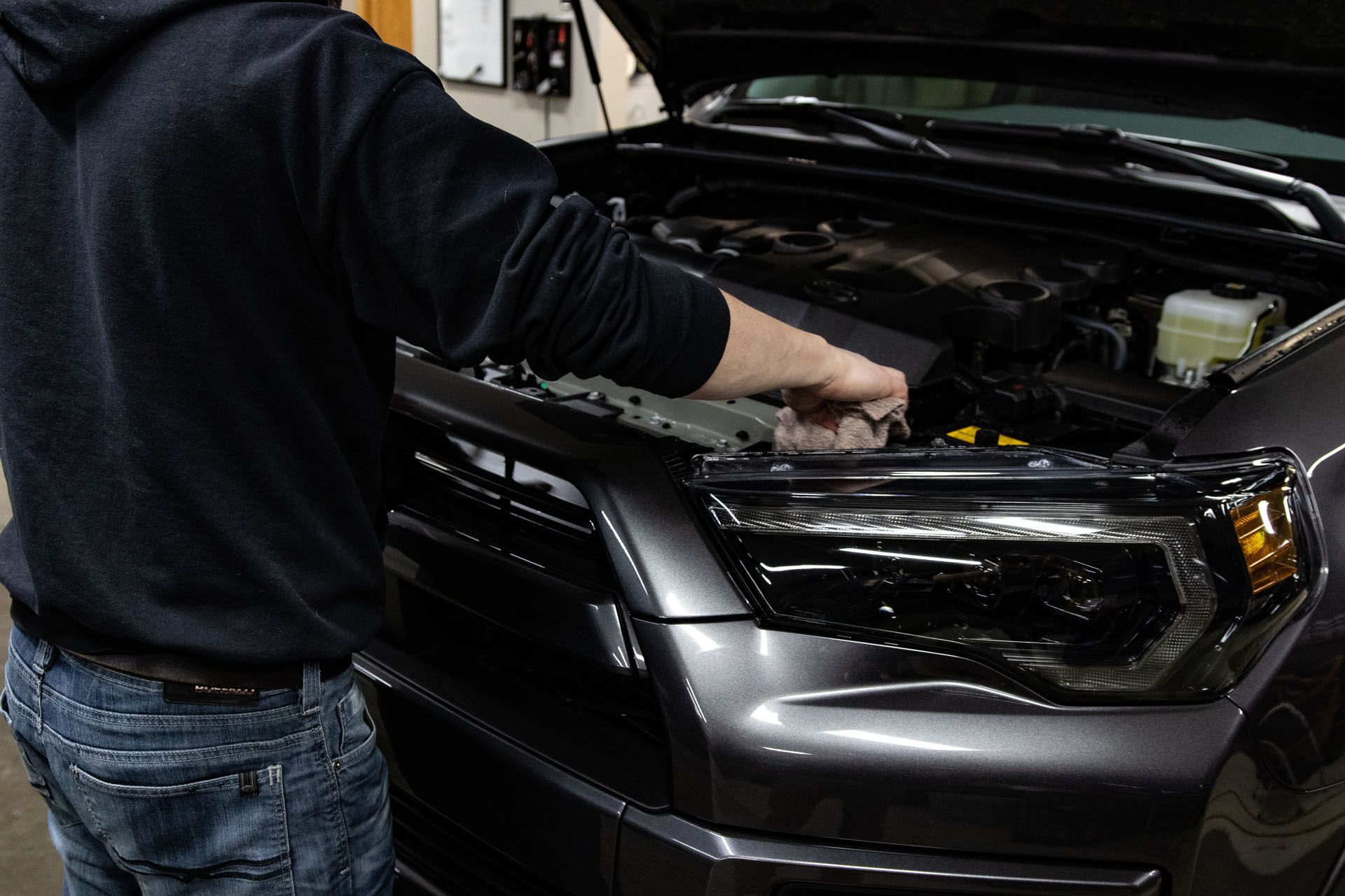 A white and yellow sports car on a black background.