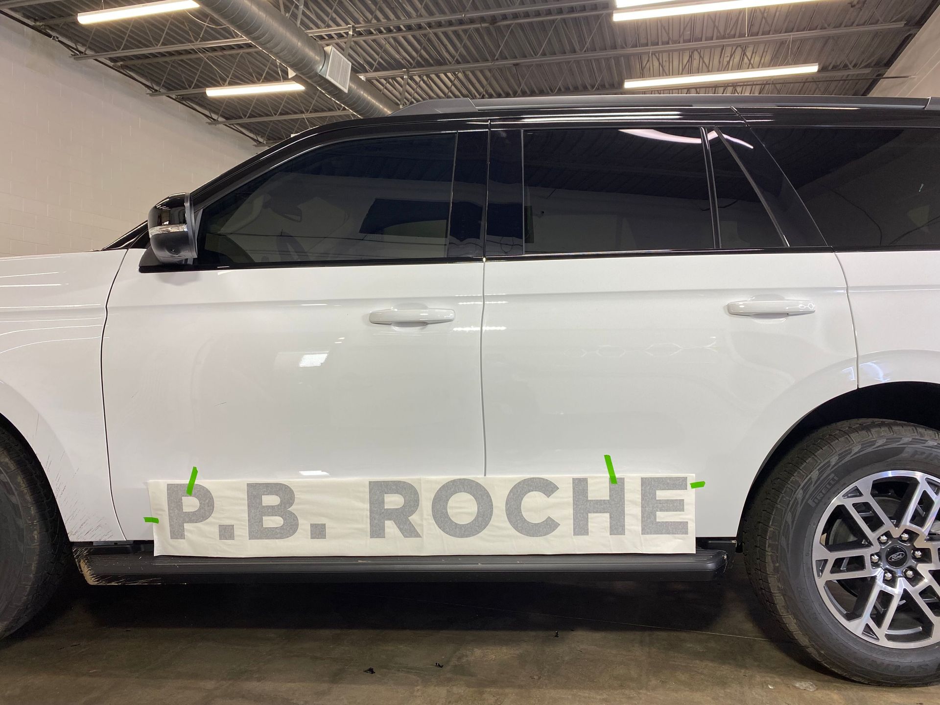 A white SUV parked indoors with a 