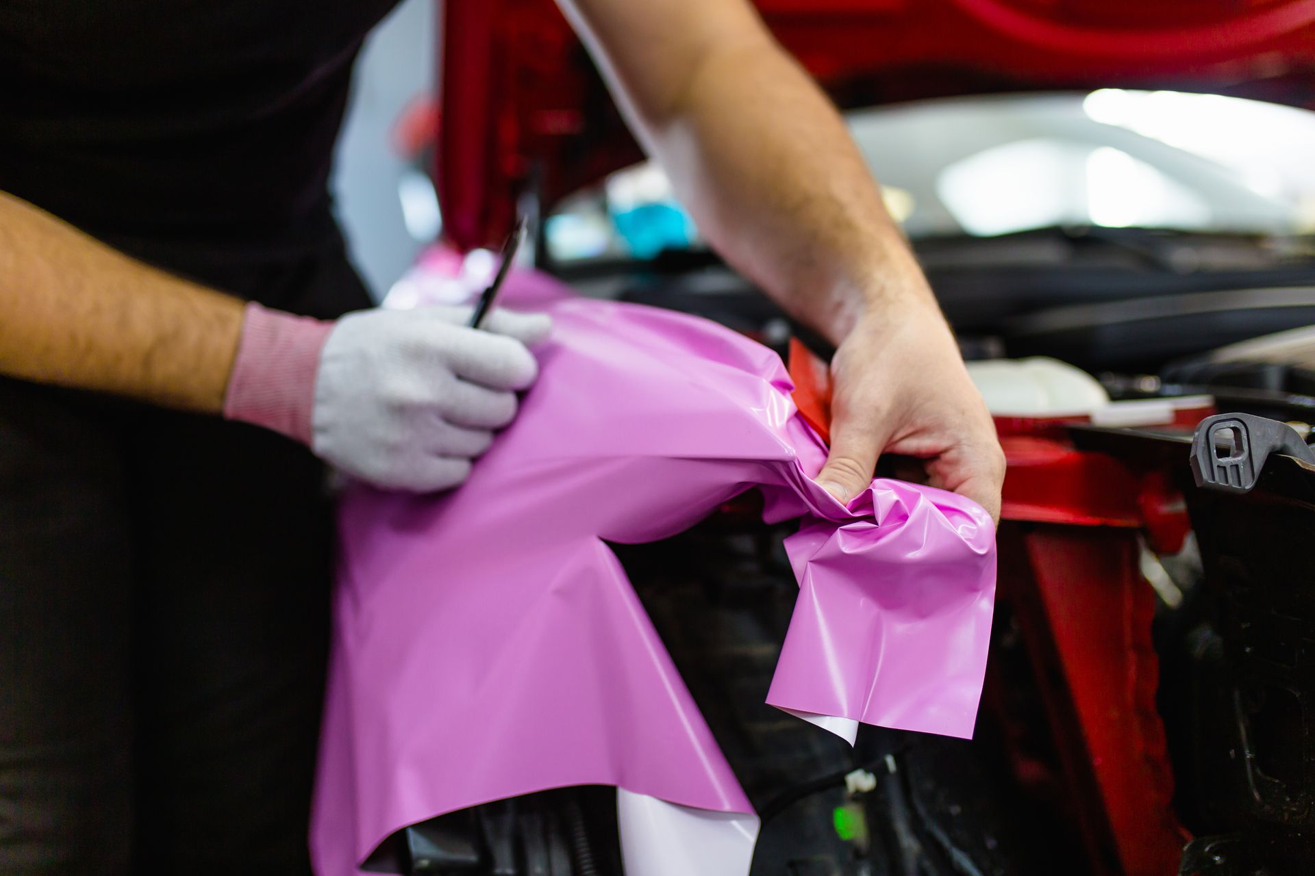 A blue Honda Civic Si parked in a dimly lit indoor parking garage.