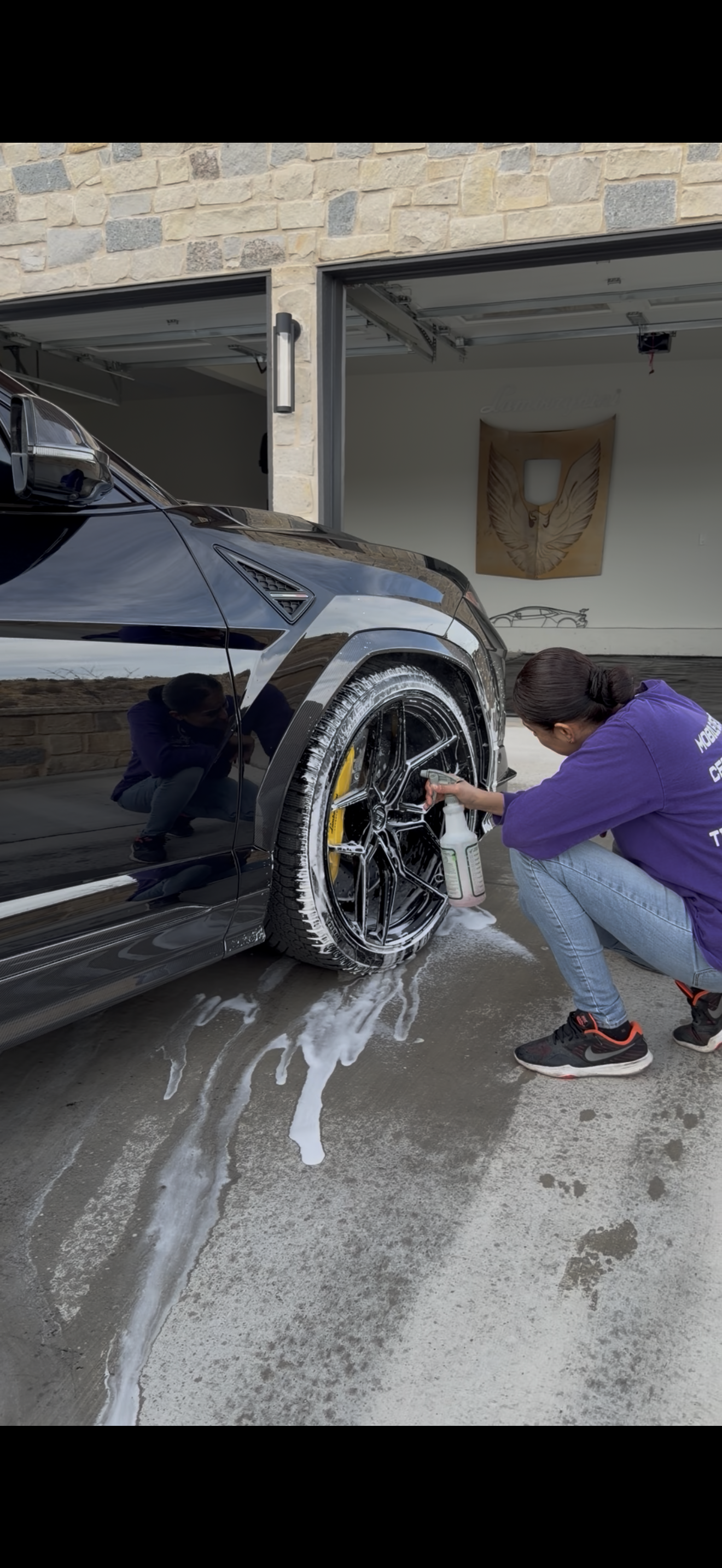 A blue Honda Civic Si parked in a dimly lit indoor parking garage.
