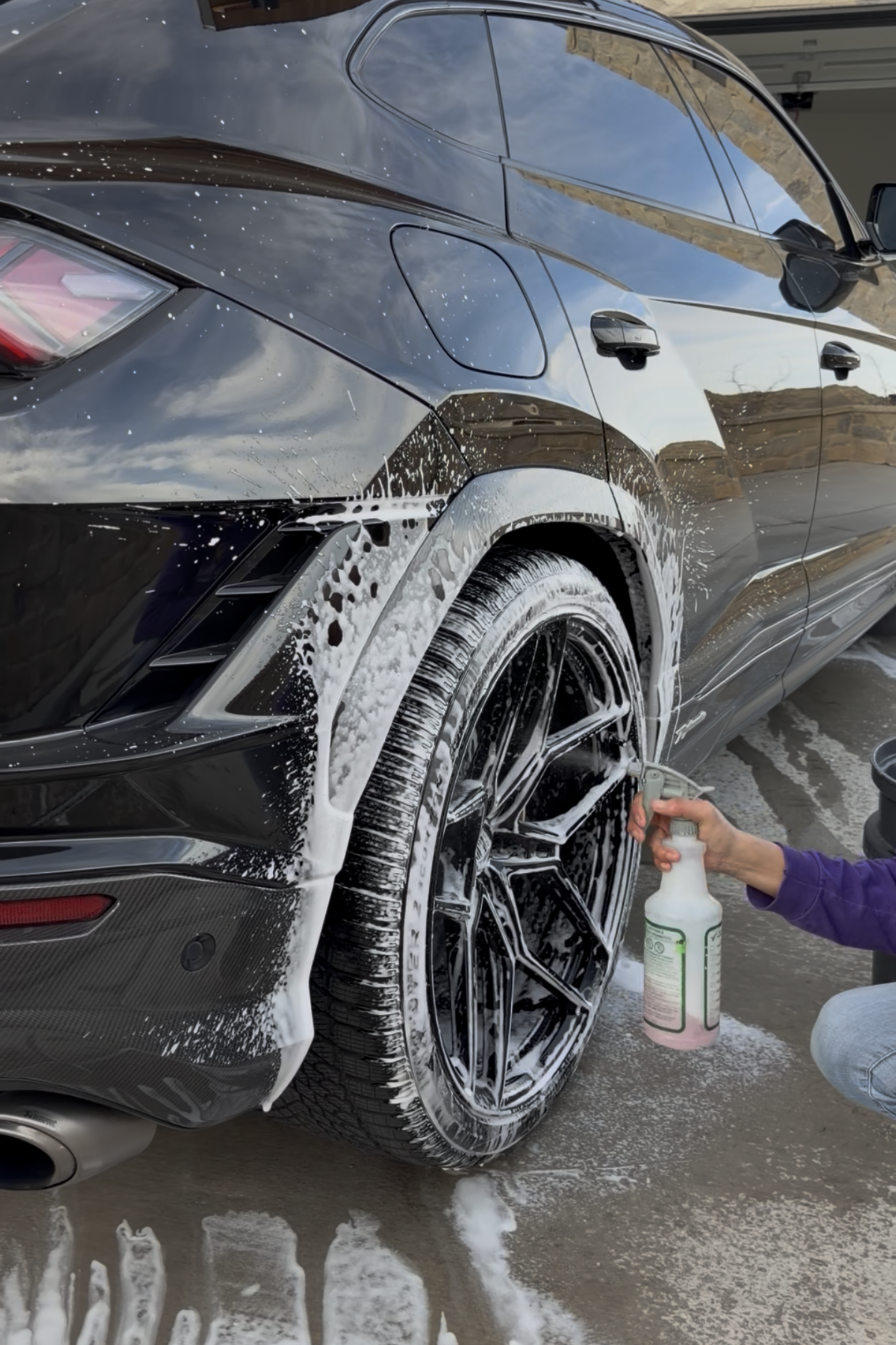 A close-up of a car's headlamp assembly, showing the sharp angle where the red painted frame meets the clear lens.