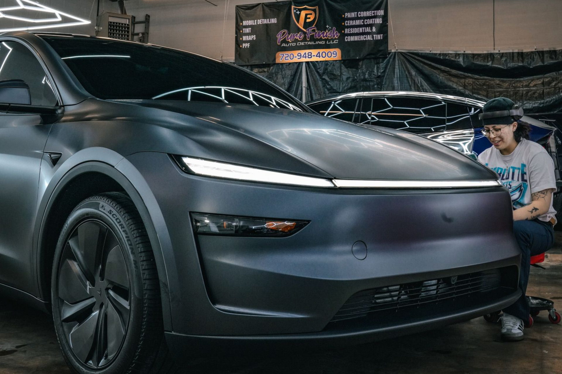 A yellow and white sports car on a black background.
