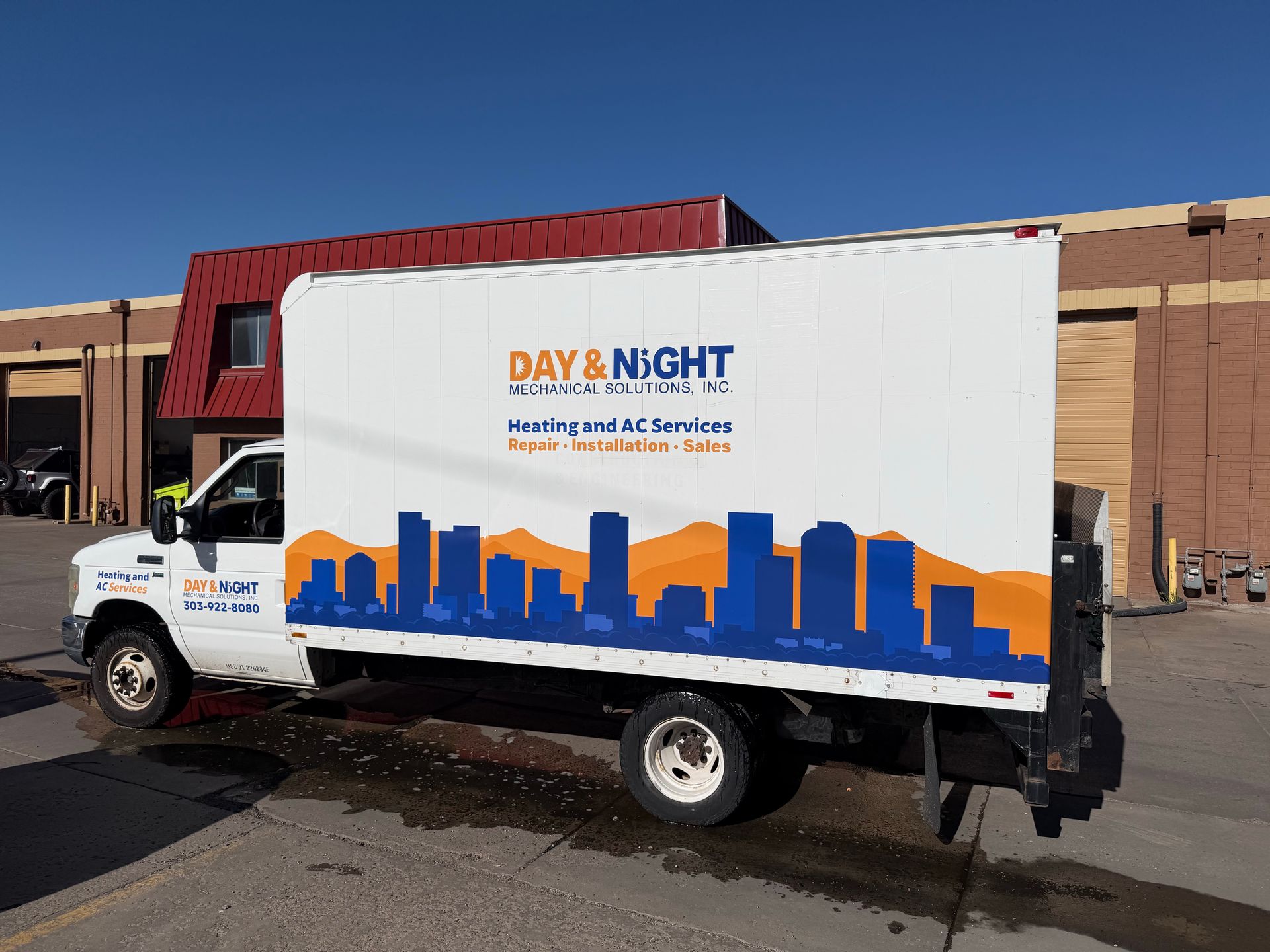 A yellow and white sports car on a black background.