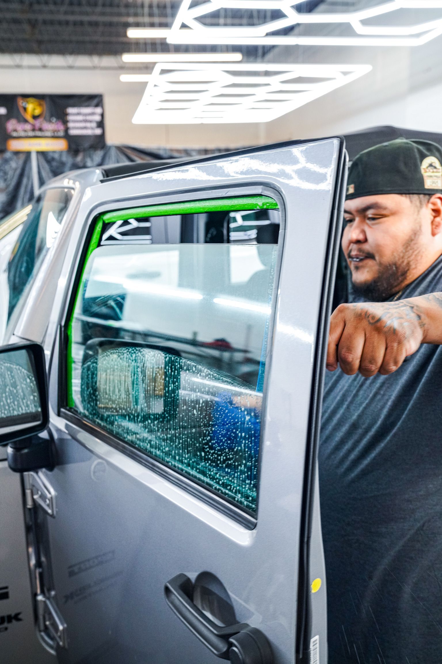 A blue Honda Civic Si parked in a dimly lit indoor parking garage.