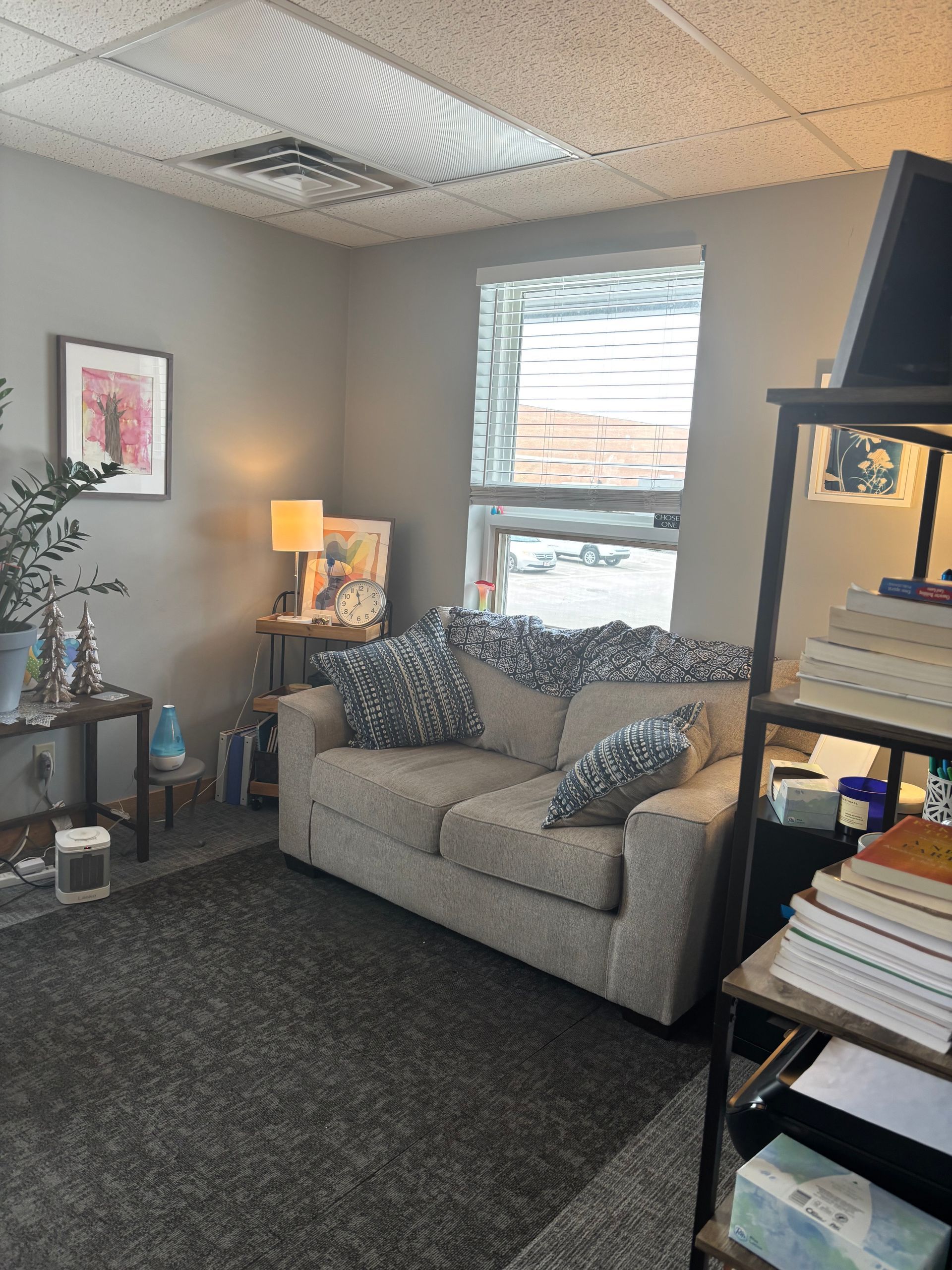 Two women are sitting on a couch talking to each other.