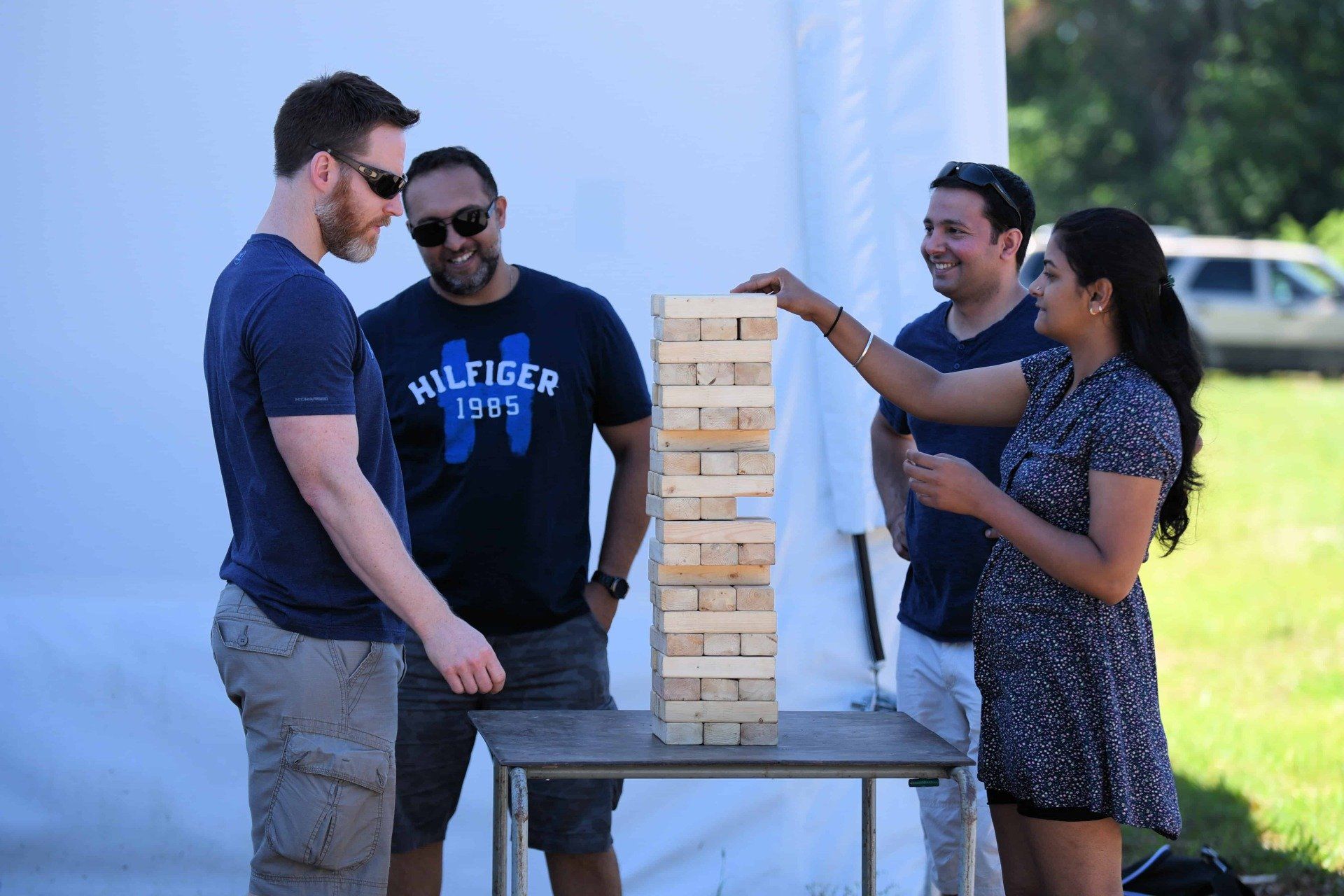 A group of people are playing a game of jenga.