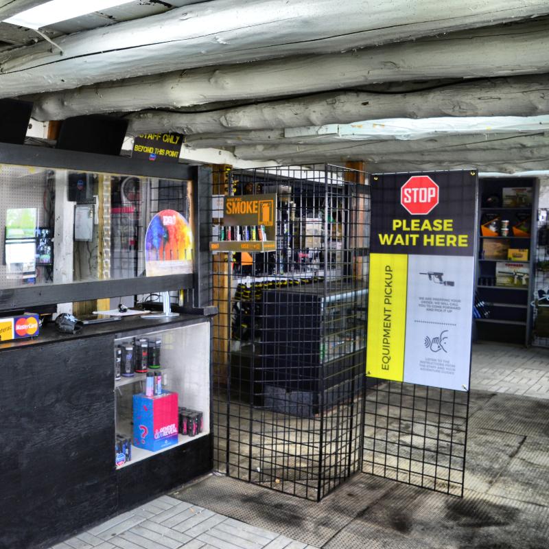 A store with a sign that says stop please wait here