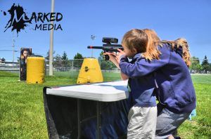 Young boy and mom playing laser tag