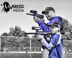 a dad and son playing laser tag