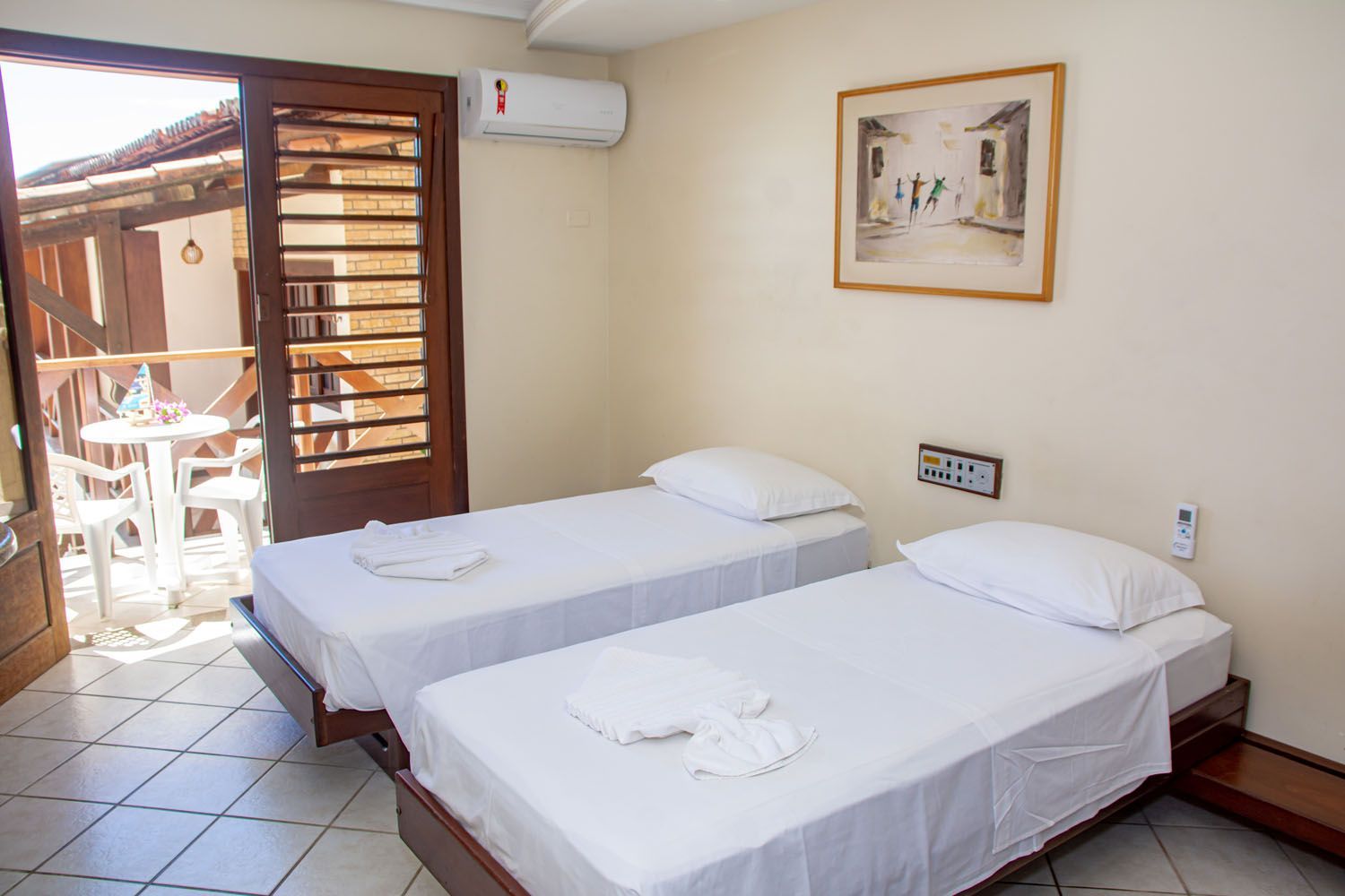 Um quarto de hotel com duas camas e varanda