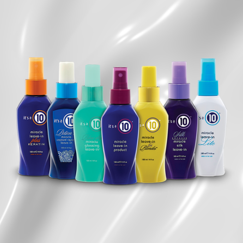 Woman with shiny brown hair and hair product bottles in a row.