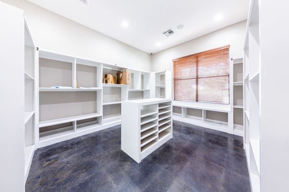 a large closet with lots of shelves and a window at Marquis at Katy in Katy, TX.