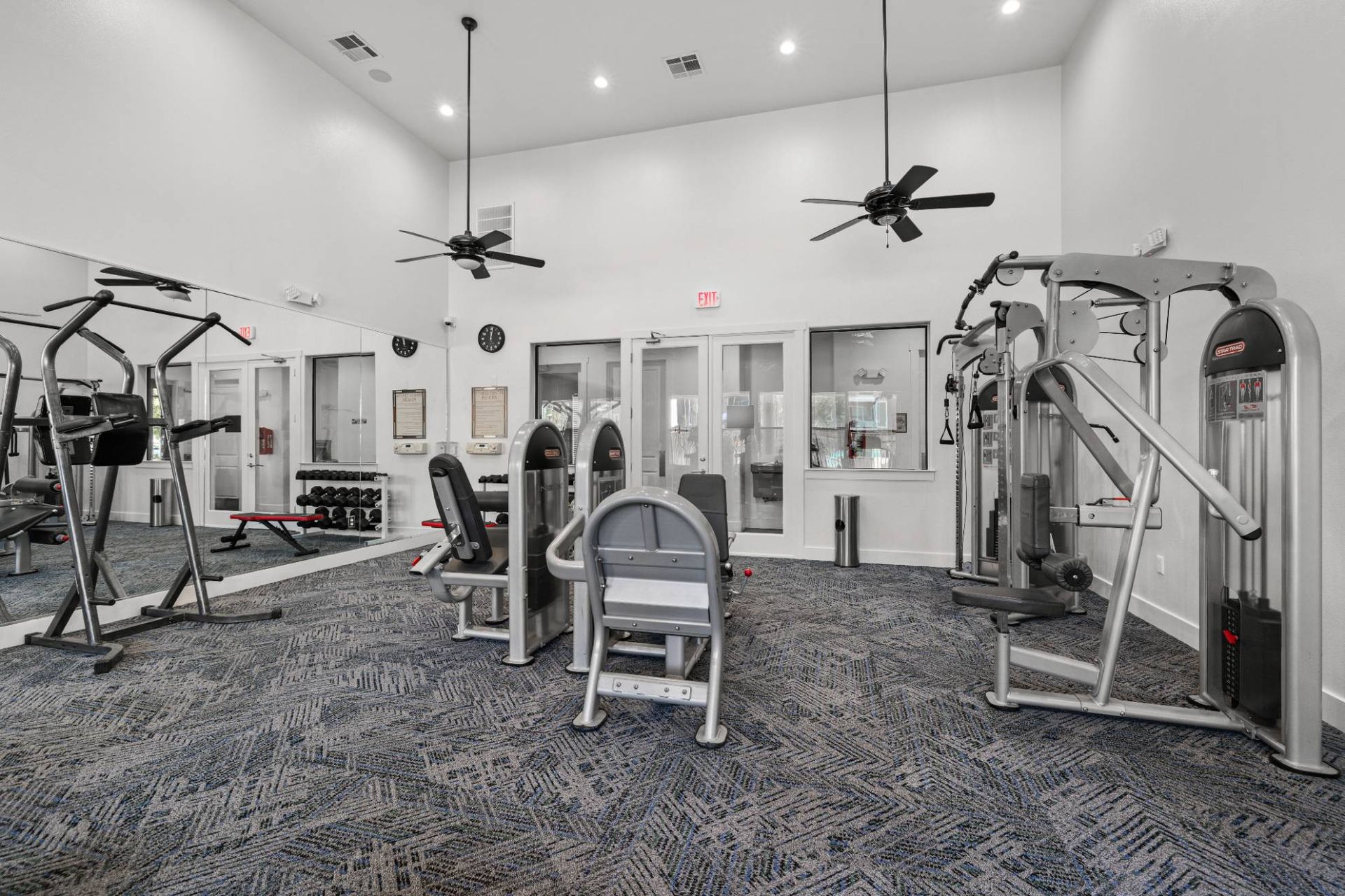 Gym interior with cardio machines and strength equipment in a resident fitness center.