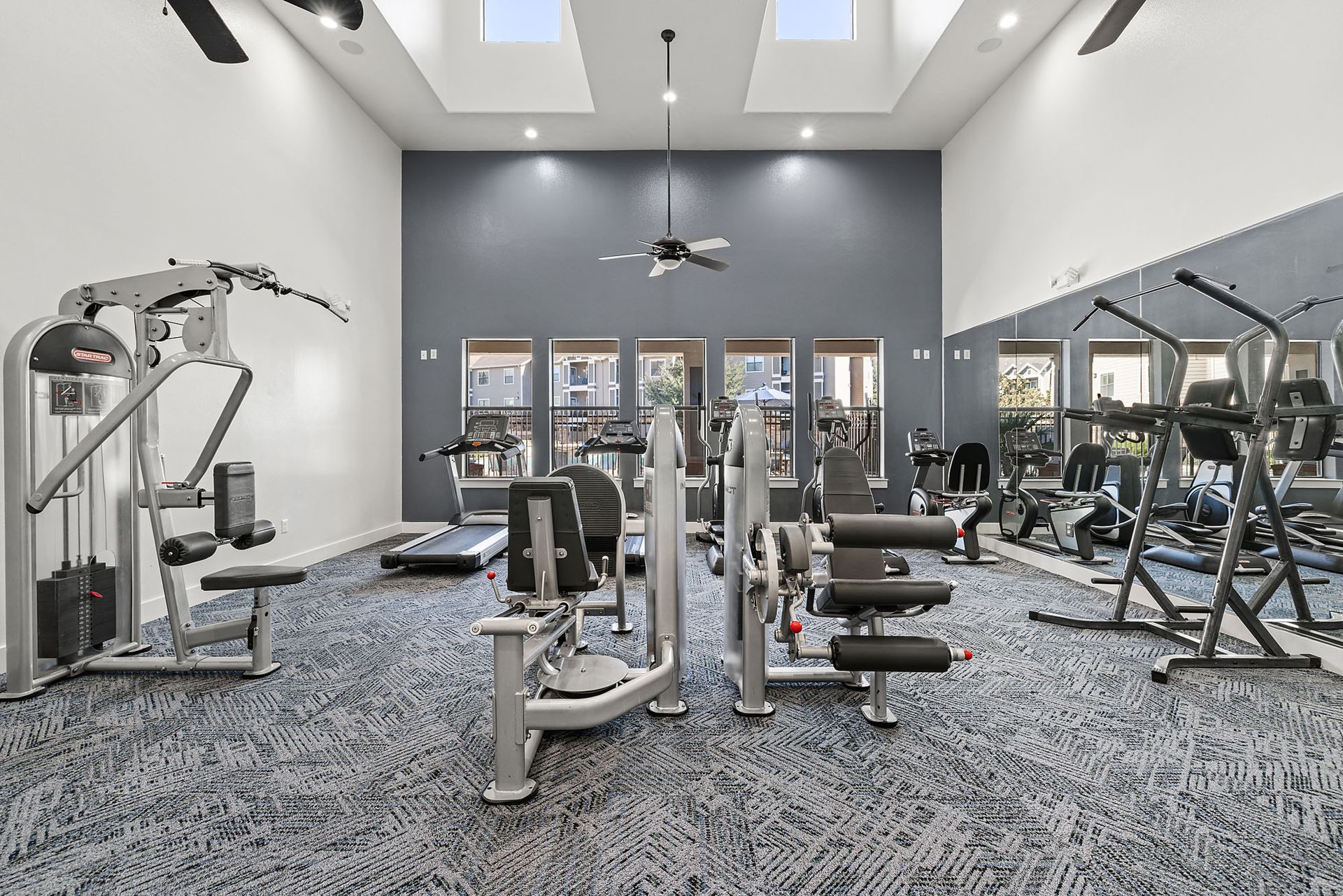 Fully equipped fitness center with cardio machines and weight training equipment.