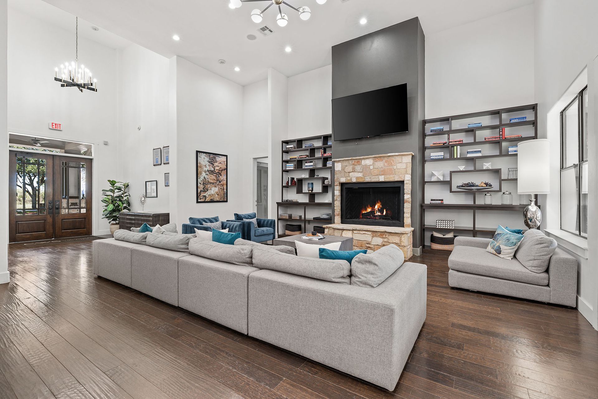 Stylish clubroom with a cozy fireplace and a large TV for resident gatherings.